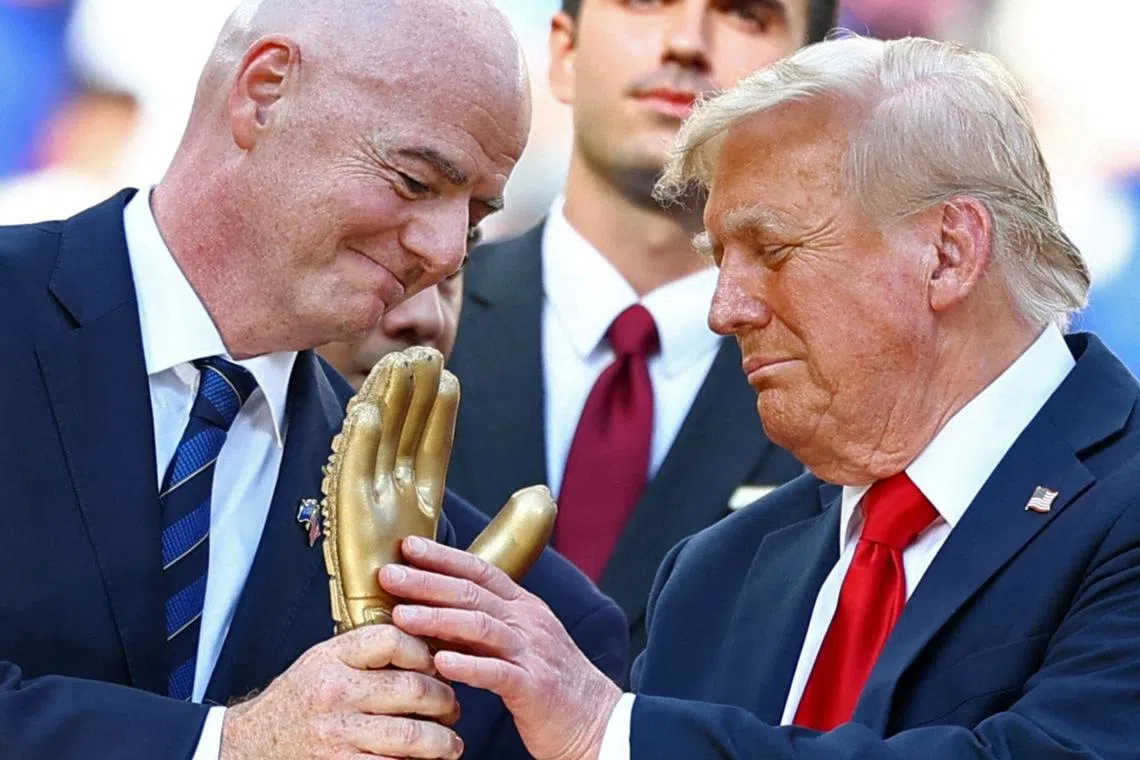 US President Donald Trump looking at the Golden Glove trophy next to Fifa president Gianni Infantino after Chelsea beat Paris Saint-Germain in the Club World Cup final at MetLife Stadium in East Rutherford, New Jersey, on July 13.