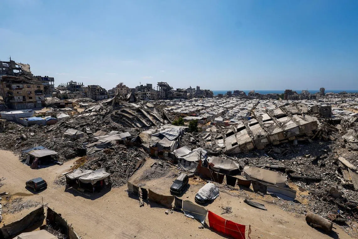 A general view of the rubble of residential buildings destroyed during the Israeli offensive and tents sheltering displaced Palestinians in Gaza City, July 4, 2026. REUTERS/Mahmoud Issa
