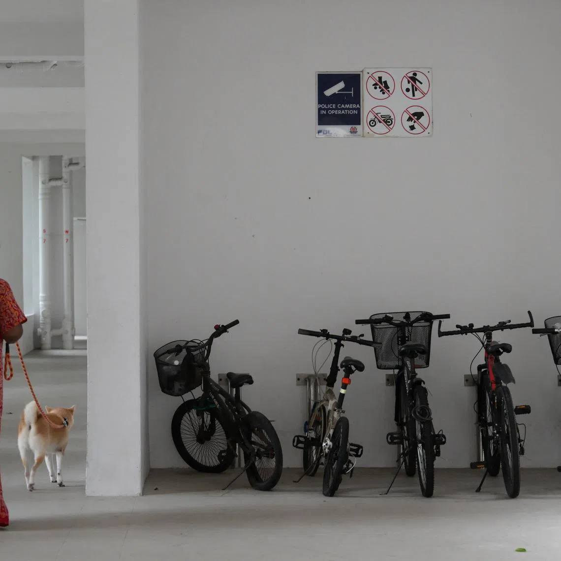 A sign indicating that football is not allowed, among other signs, at a void deck of an HDB block.