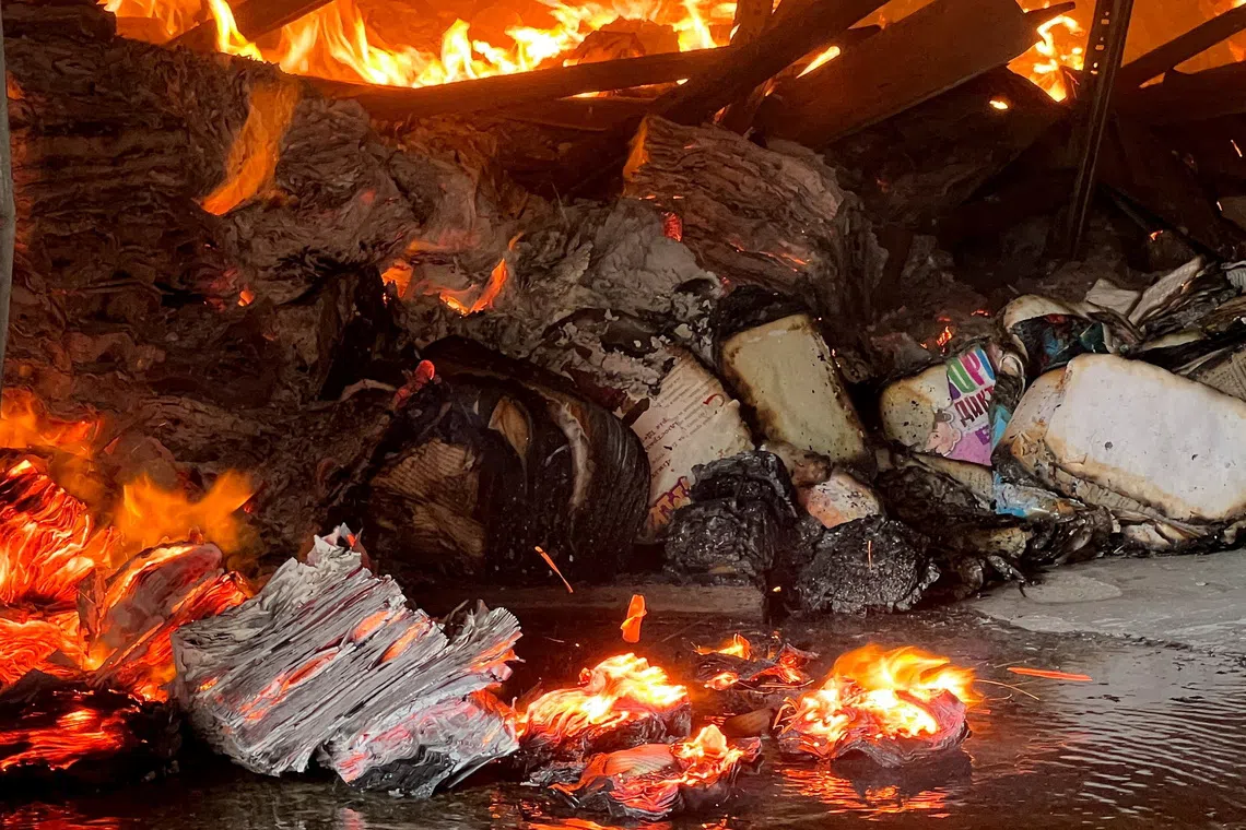 FILE PHOTO: Books burn at the site of a book warehouse hit by a Russian drone strike, amid Russia's attack on Ukraine, in Kharkiv, Ukraine, August 1, 2026. REUTERS/Volodymyr Pavlov/File Photo