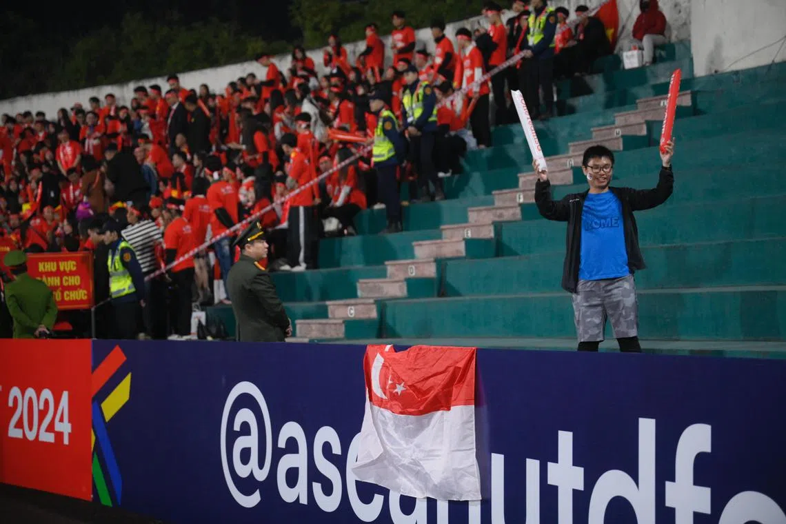 Ong Wee Harn (right), 28, a Singaporean content creator, was one of the supporters during the ASEAN Mitsubishi Electric Cup semi final second leg held at the Viet Tri Stadium in Phu Tho, Vietnam, on Dec 29, 2024.