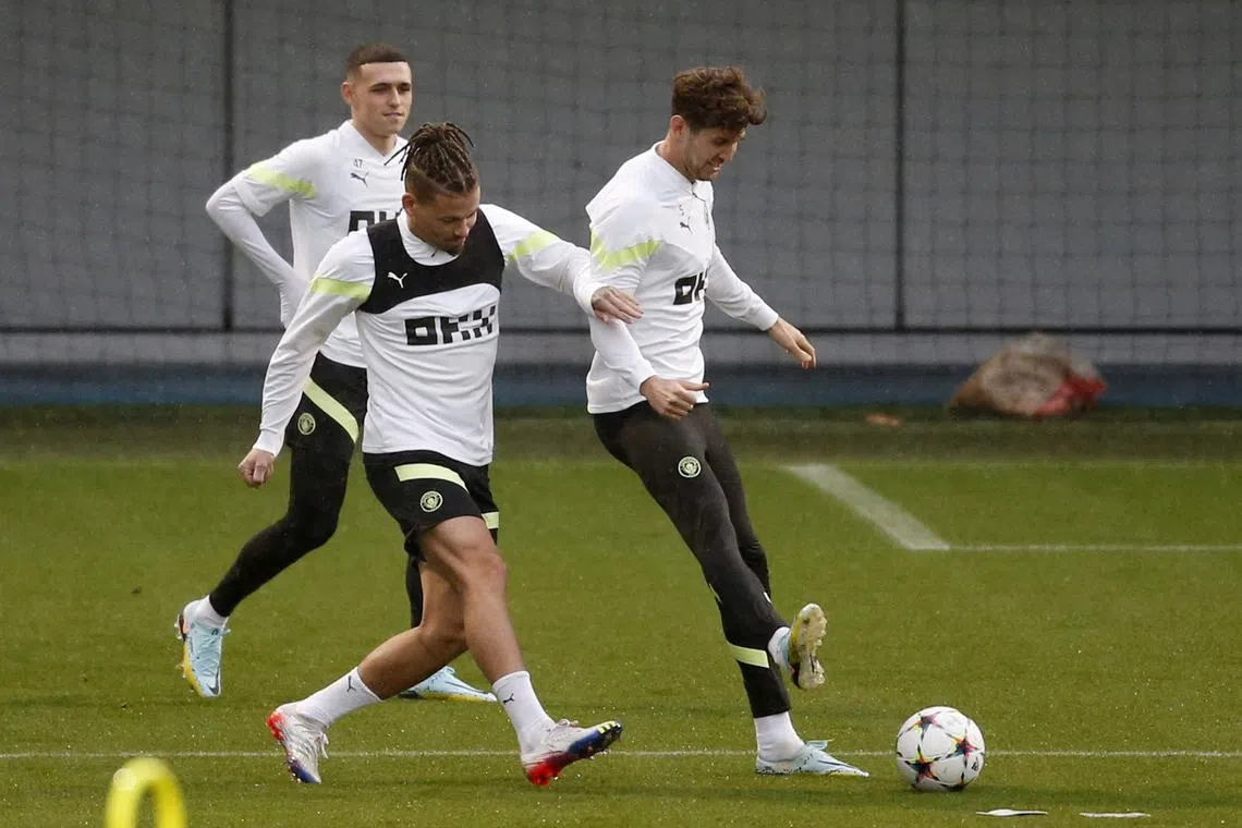 Manchester City's Kalvin Phillips (front), Phil Foden (behind) and John Stones during training on Nov 1, 2022.