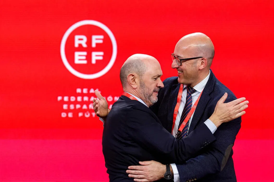 Newly elected Spanish Football Federation president Rafael Louzan (left) embraces Galician Football executive Luis Serantes after being elected.