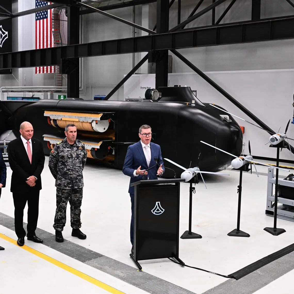 Australia’s Minister for Defence Industry Pat Conroy (right) speaking to the media in front of the Ghost Shark autonomous undersea vehicles on Oct 19.