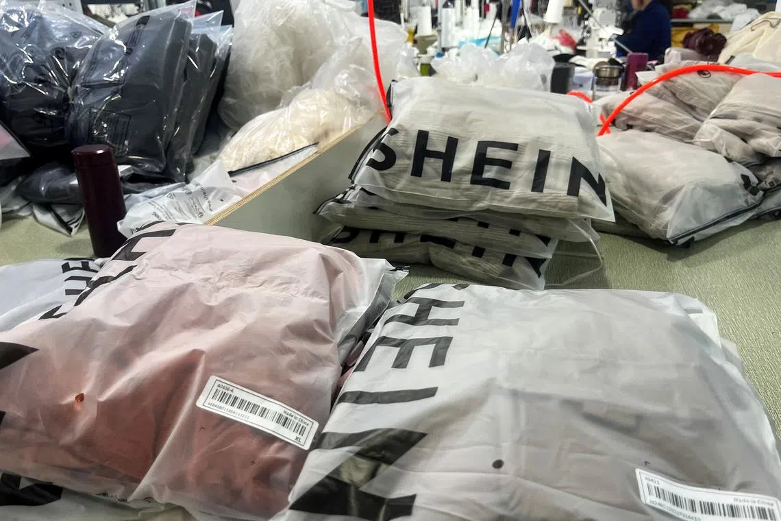 FILE PHOTO: Packs of clothing are pictured at a garment factory for Shein in Guangzhou, Guangdong province, China April 1, 2025. REUTERS/Casey Hall/File Photo