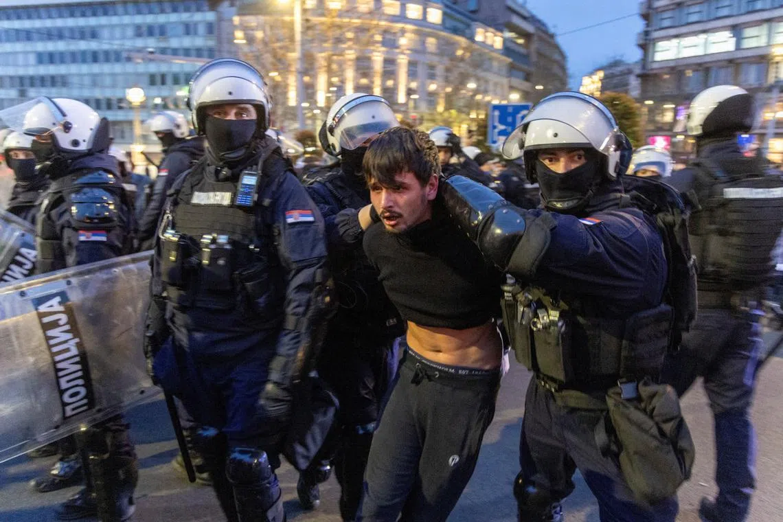 Police officers detain a demonstrator as people rally to protest police search of Belgrade's university offices after the accidental death of a student last week, in Belgrade, Serbia, March 31, 2026. REUTERS/Djordje Kojadinovic