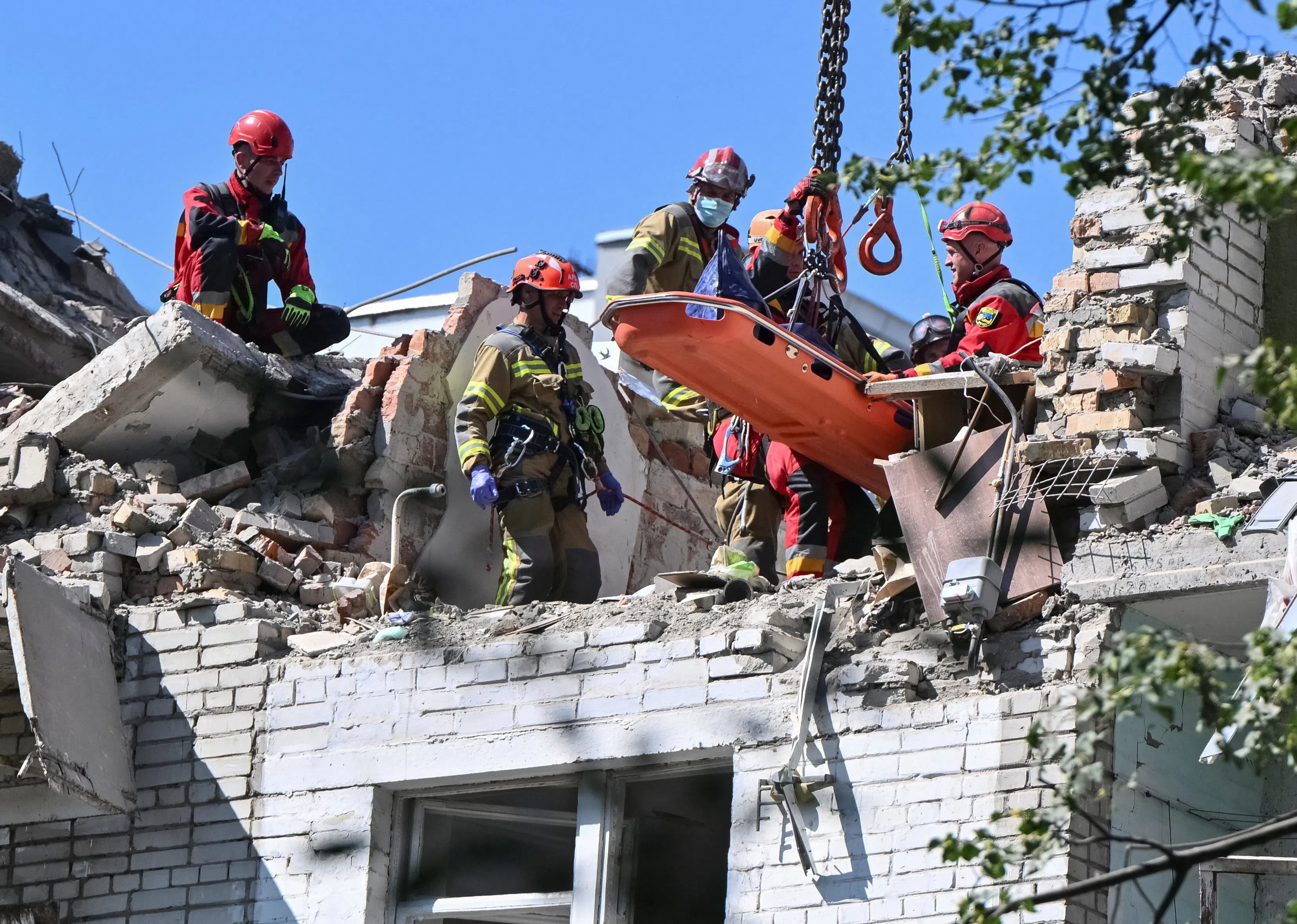 Rescuers using a crane to remove the body of a person killed in a Russian missile strike on an apartment building in Lviv, Ukraine, on July 30.
