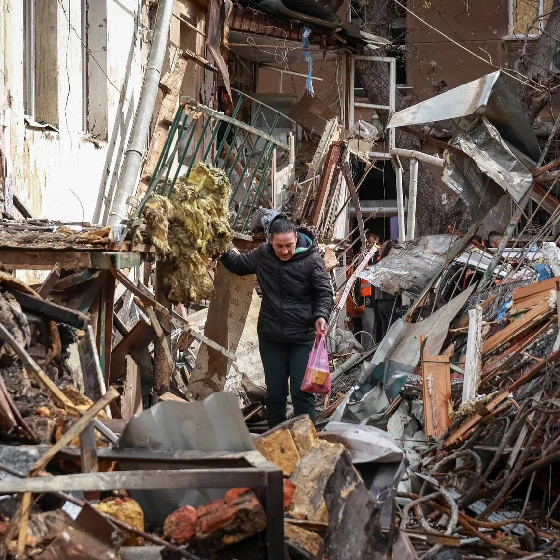 A resident walks at the site of an apartment building hit by a Russian drone strike, amid Russia's attack on Ukraine, in Odesa, Ukraine, April 24, 2026. REUTERS/Nina Liashonok