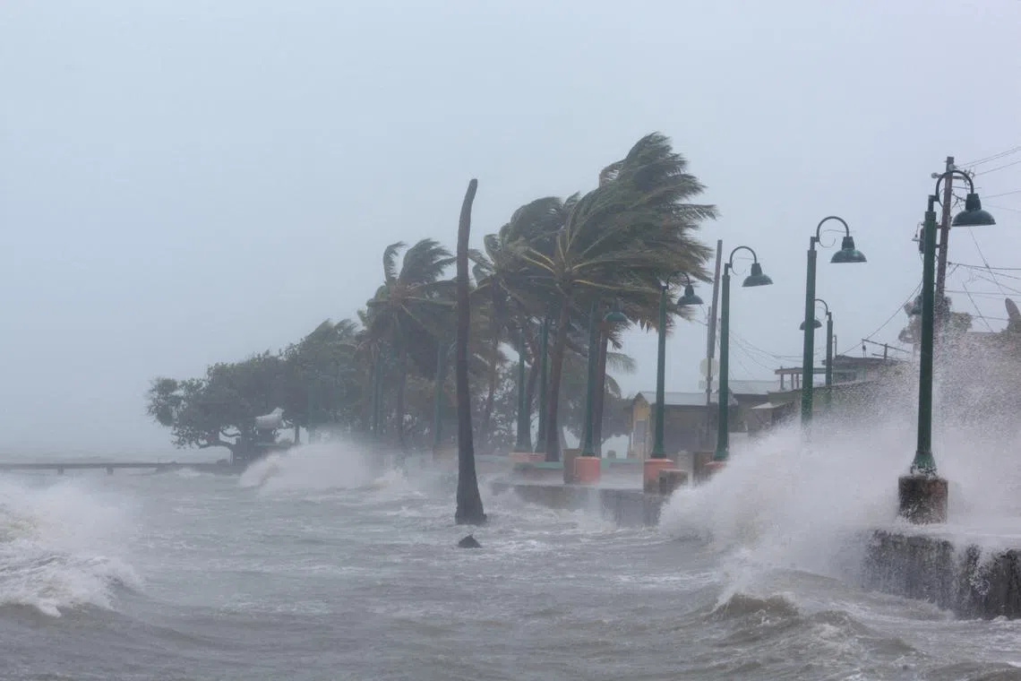 FILE PHOTO: Waves crash against the seawall as Hurricane Irma slammed across islands in the northern Caribbean on Wednesday, in Fajardo, Puerto Rico September 6, 2017.  REUTERS/Alvin Baez//File Photo