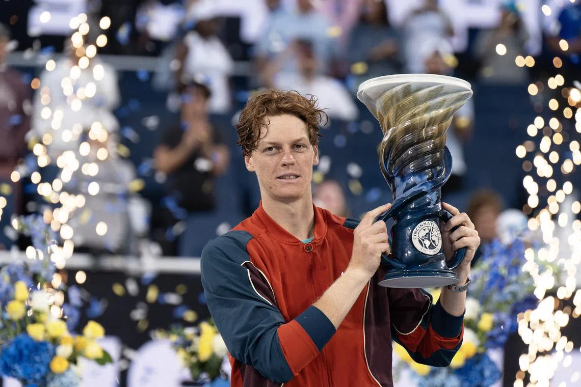 Aug 19 2024; Cincinnati, OH, USA; Jannik Sinner of Italy poses with the Rookwood Cup trophy after winning the men’s singles final against Frances Tiafoe of the United States on day seven of the Cincinnati Open. Mandatory Credit: Susan Mullane-USA TODAY Sports