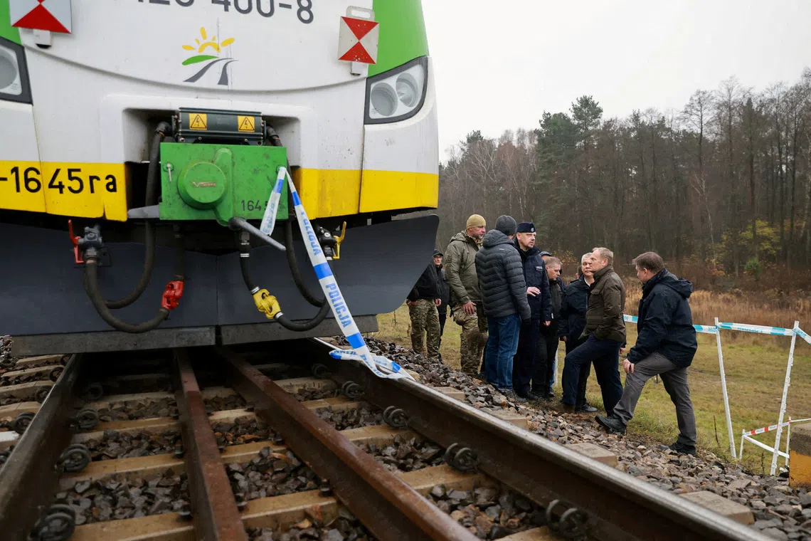 FILE PHOTO: Koleje Mazowieckie train sits on the track with police tape as Polish Prime Minister Donald Tusk visits the site of a blast on railway of the Warsaw-Lublin line in Mika, Poland, November 17, 2025. KPRM/Handout via REUTERS/File Photo