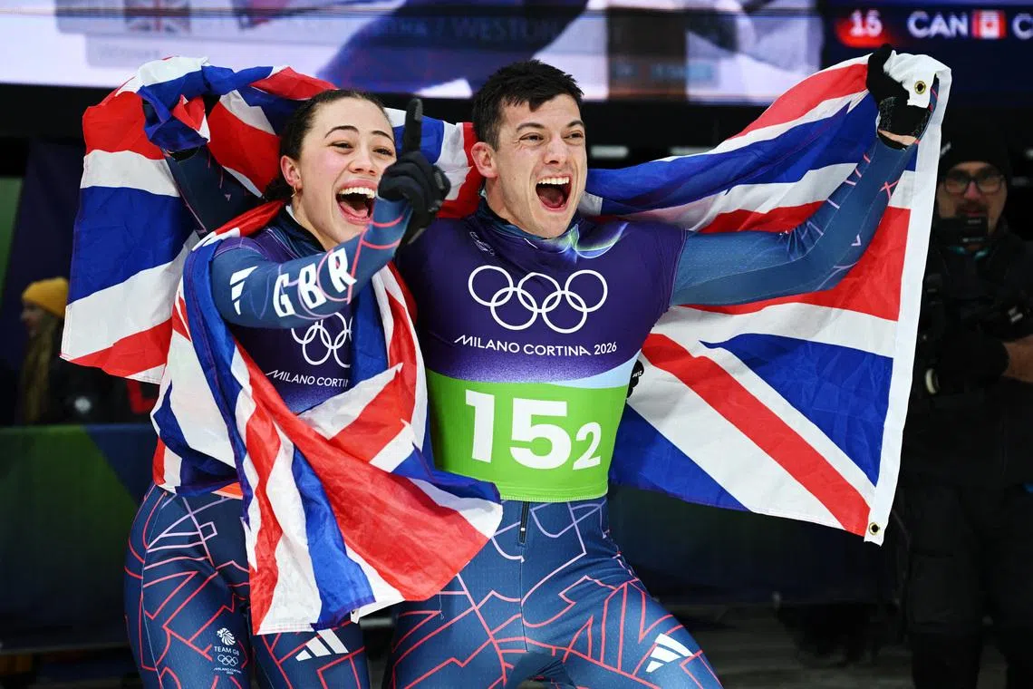 Milano Cortina 2026 Olympics - Skeleton - Mixed Team - Cortina Sliding Centre, Cortina d'Ampezzo, Italy - February 15, 2026. Tabitha Stoecker of Britain and Matt Weston of Britain celebrate after winning the gold medal in the Skeleton Mixed Team. REUTERS/Annegret Hilse