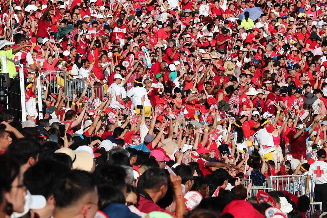 The Padang awash in a sea of red as spectators watch the National Day Parade on Aug 9, 2023. ST PHOTO: BENJAMIN SEETOR