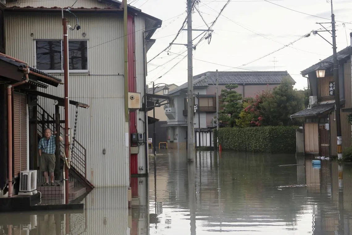 FILE PHOTO: A man stands at a residential area affected by the flooding of the Kuise River caused by Typhoon Shanshan in Ogaki, Gifu prefecture, central Japan August 31, 2024, in this photo taken by Kyodo. Mandatory credit Kyodo/via REUTERS/File Photo