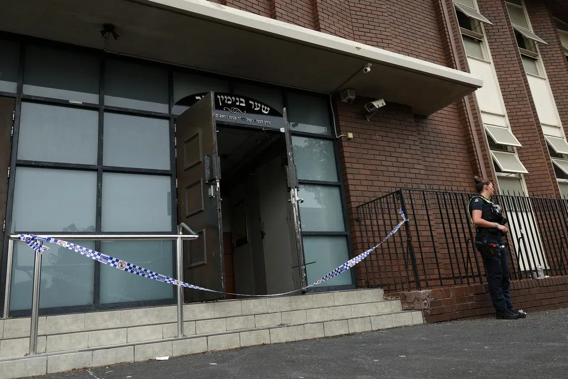 FILE PHOTO: A policewoman stands guard at the scene of a fire at the Adass Israel Synagogue in Ripponlea, Melbourne, Australia, December 6, 2024. AAP Image/Con Chronis via REUTERS/File Photo