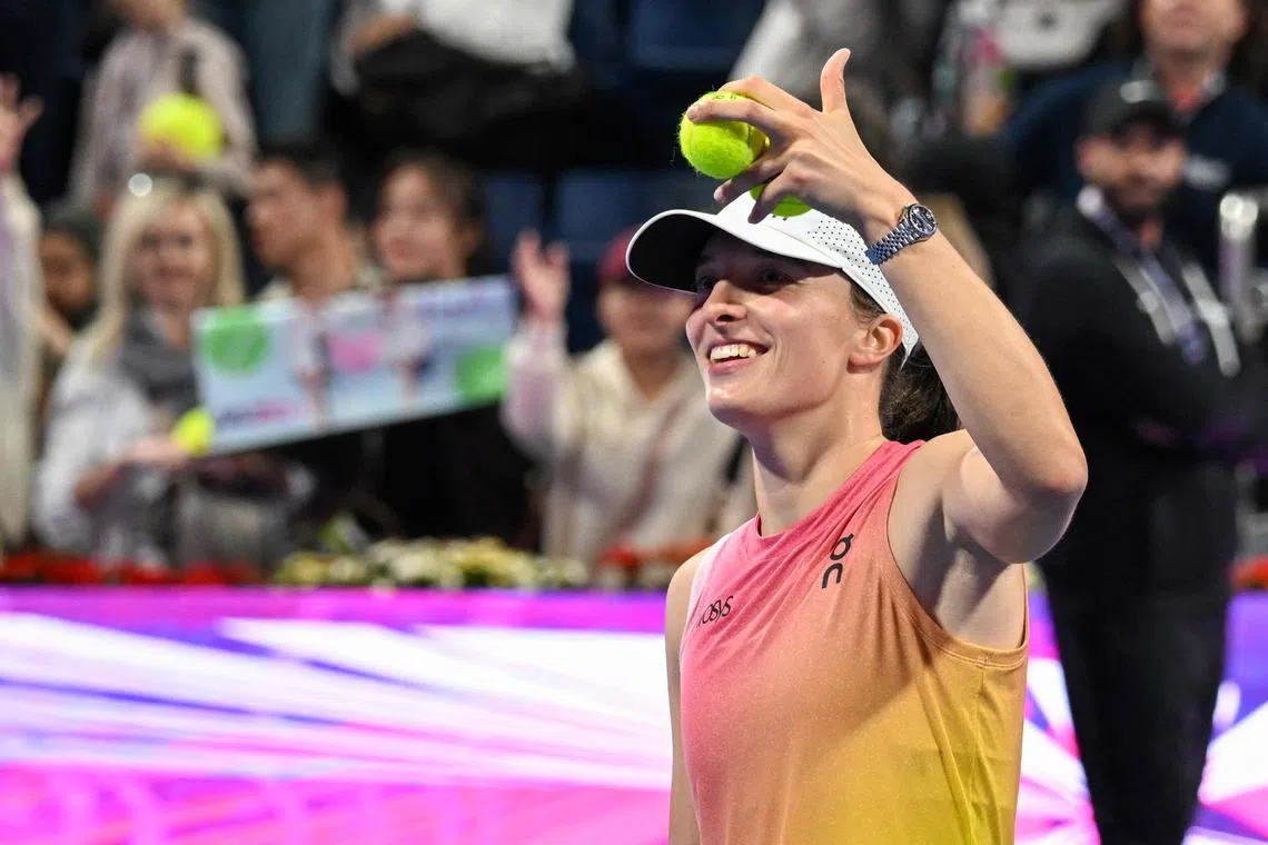 Poland's Iga Swiatek gestures after winning the 2025 WTA Qatar Open quarter-final tennis match against Kazakhstan's Elena Rybakina.