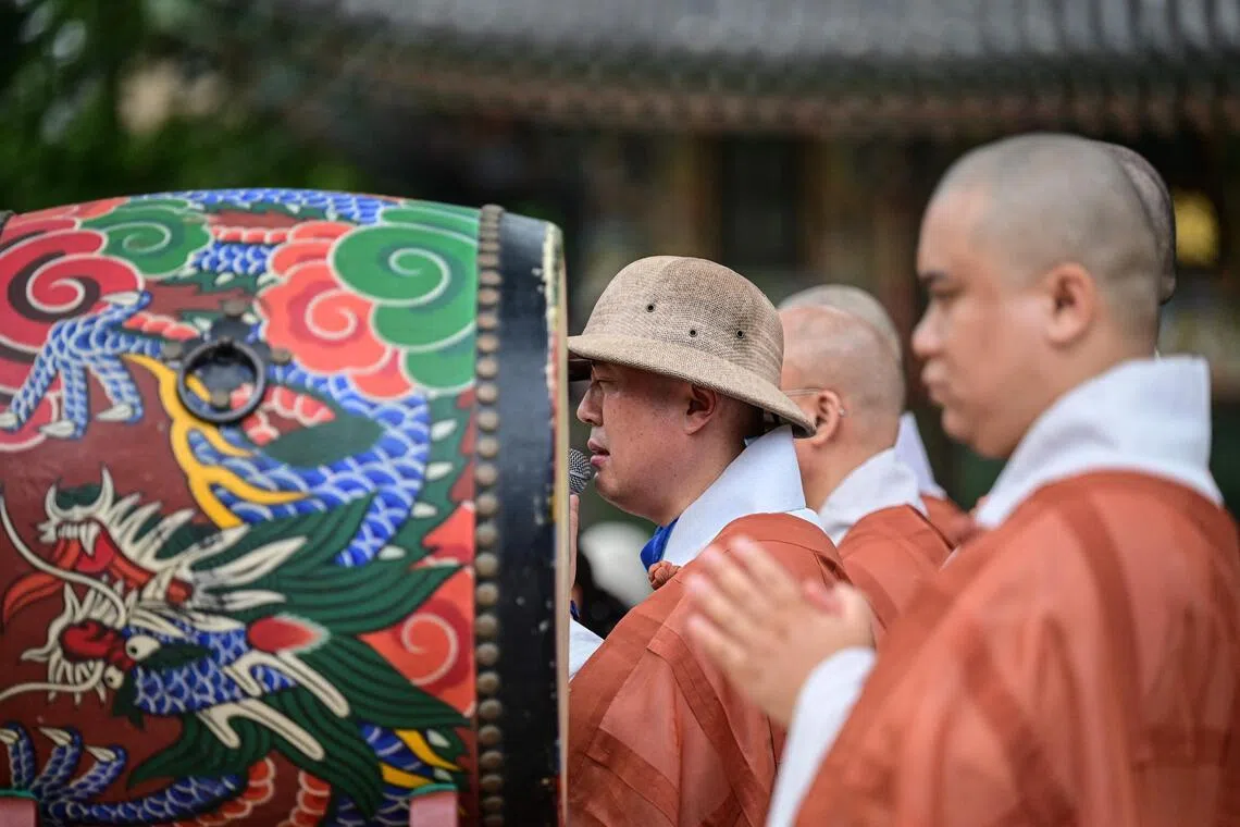 Buddhist monks offering prayers at Jogyesa Temple in Seoul on July 2.