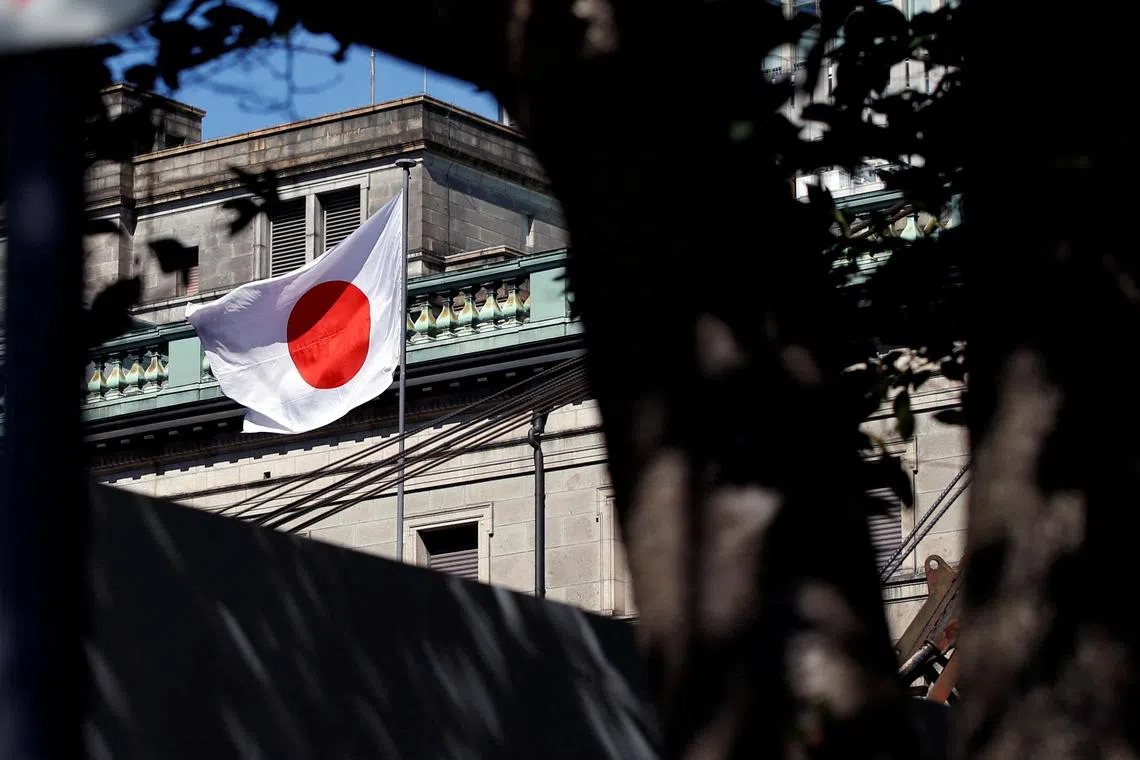 FILE PHOTO: A Japanese flag flutters atop the Bank of Japan building under construction in Tokyo, Japan, September 21, 2017.   REUTERS/Toru Hanai/File Photo