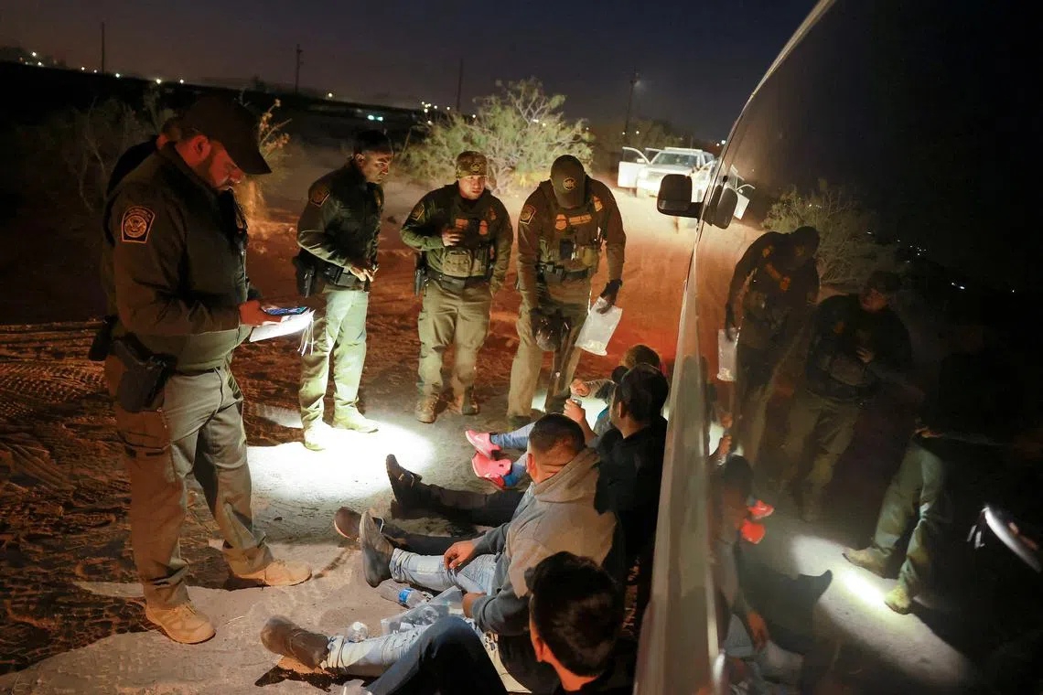 FILE PHOTO: Migrants are detained by U.S. Border Patrol agents after crossing into the United States from Mexico, in Sunland Park, New Mexico, U.S. October 24, 2024. REUTERS/Jose Luis Gonzalez/File Photo