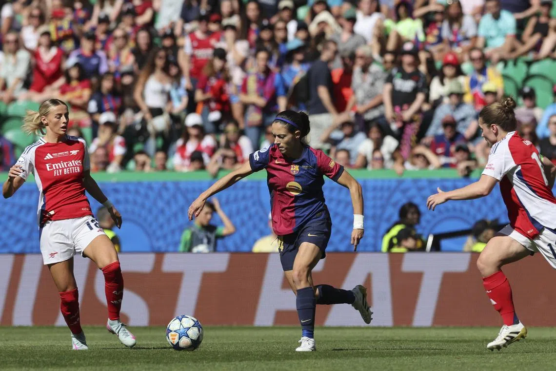 Arsenal player Chloe Kelly (left) and Barcelona player Aitana Bonmati (centre) in action during the Women's Champions League final between Arsenal and Barcelona at the Jose Alvalade Stadium in Lisbon, Portugal.
