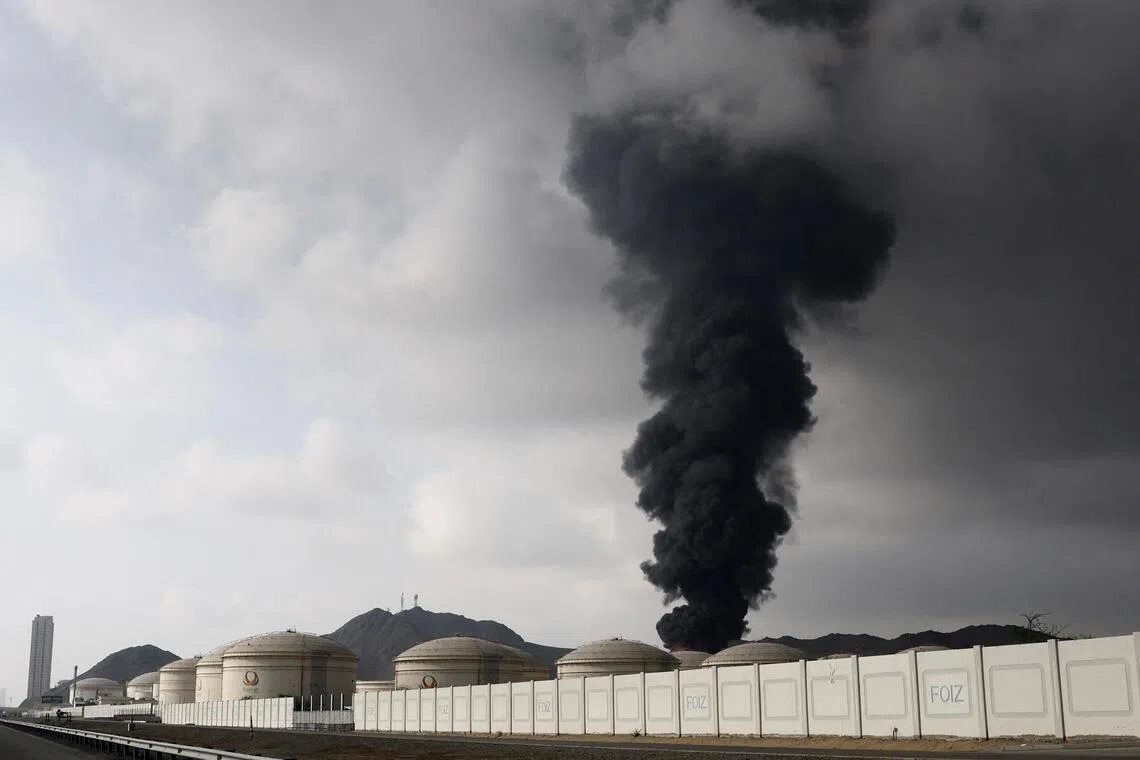 Smoke rises in the Fujairah oil industry zone following a fire caused by debris after interception of a drone by air defenses, according to the Fujairah media office, amid the US-Israel conflict with Iran, in Fujairah, United Arab Emirates.