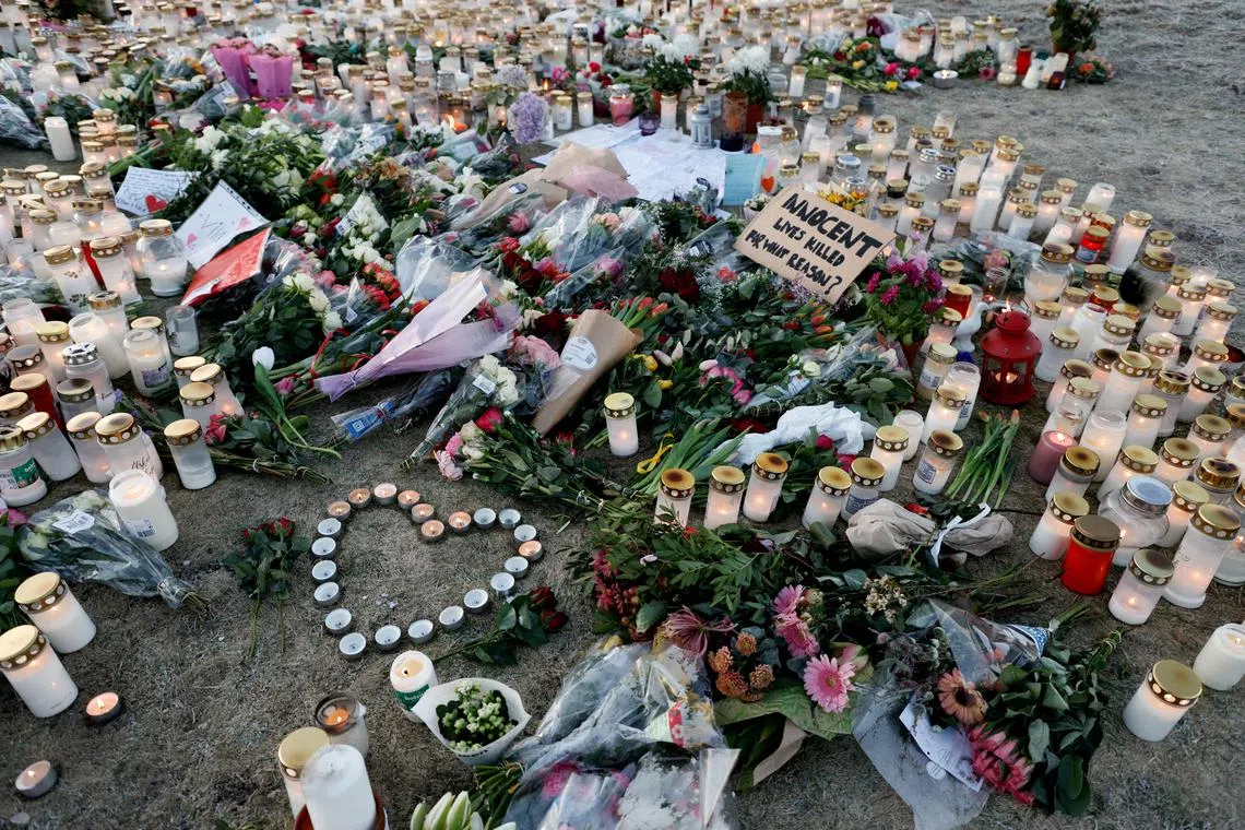 FILE PHOTO: Candles and flowers are placed near the Risbergska school, following a deadly shooting attack at the adult education centre, in Orebro, Sweden, February 7, 2025. REUTERS/Kuba Stezycki/File Photo