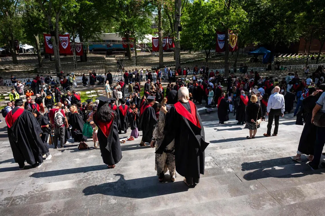 Students, faculty and family pose for pictures at Harvard Yard on May 28.