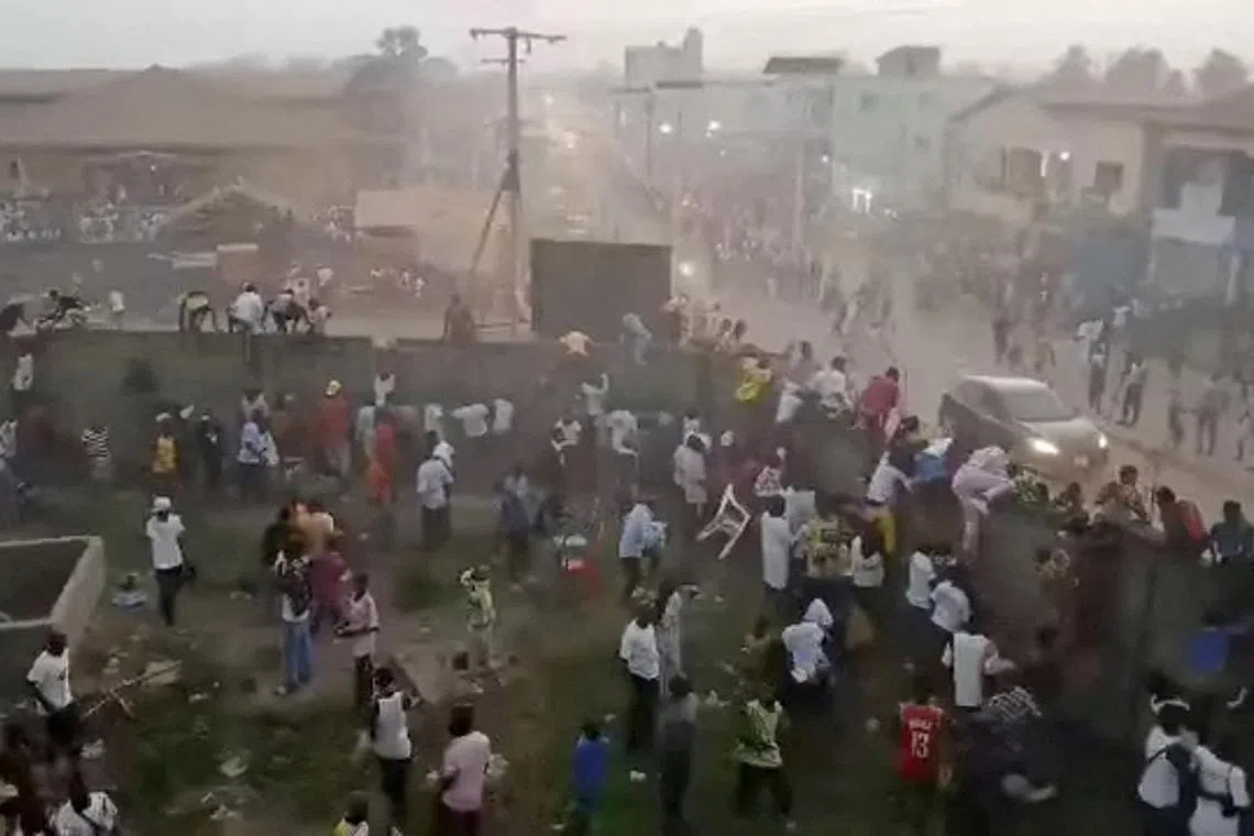 FILE PHOTO: People scramble in Nzerekore, Guinea, where local officials said a deadly crush ensued at a stadium following fan clashes during a soccer match, December 1, 2024, in this still image obtained from a social media video. Social media via REUTERS/File Photo