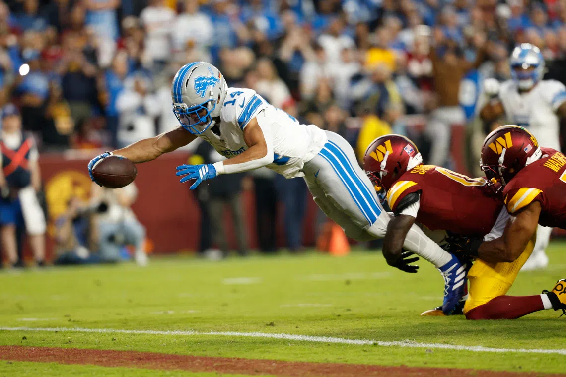 Washington Commanders quarterback Josh Johnson dives for a touchdown during the first quarter at Northwest Stadium on Nov 9. 