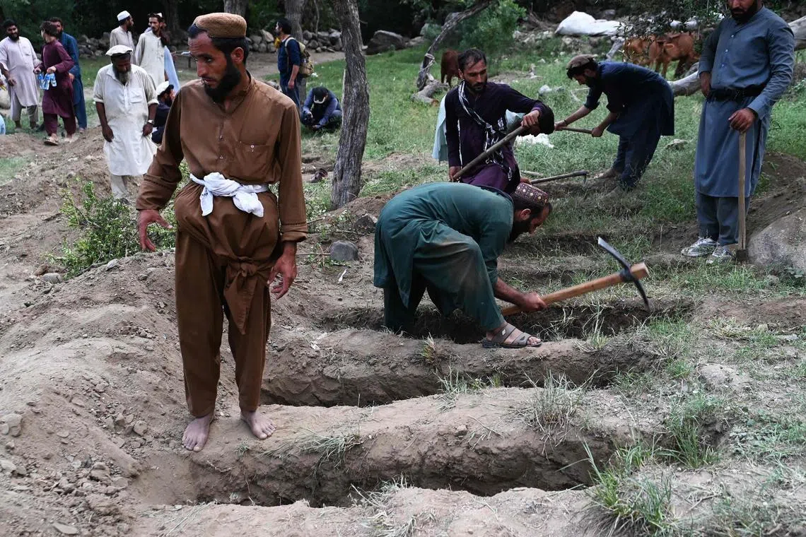 Volunteers digging graves for people who died during a deadly Aug 31 earthquake, in Afghanistan's Kunar province, on Sept 1.