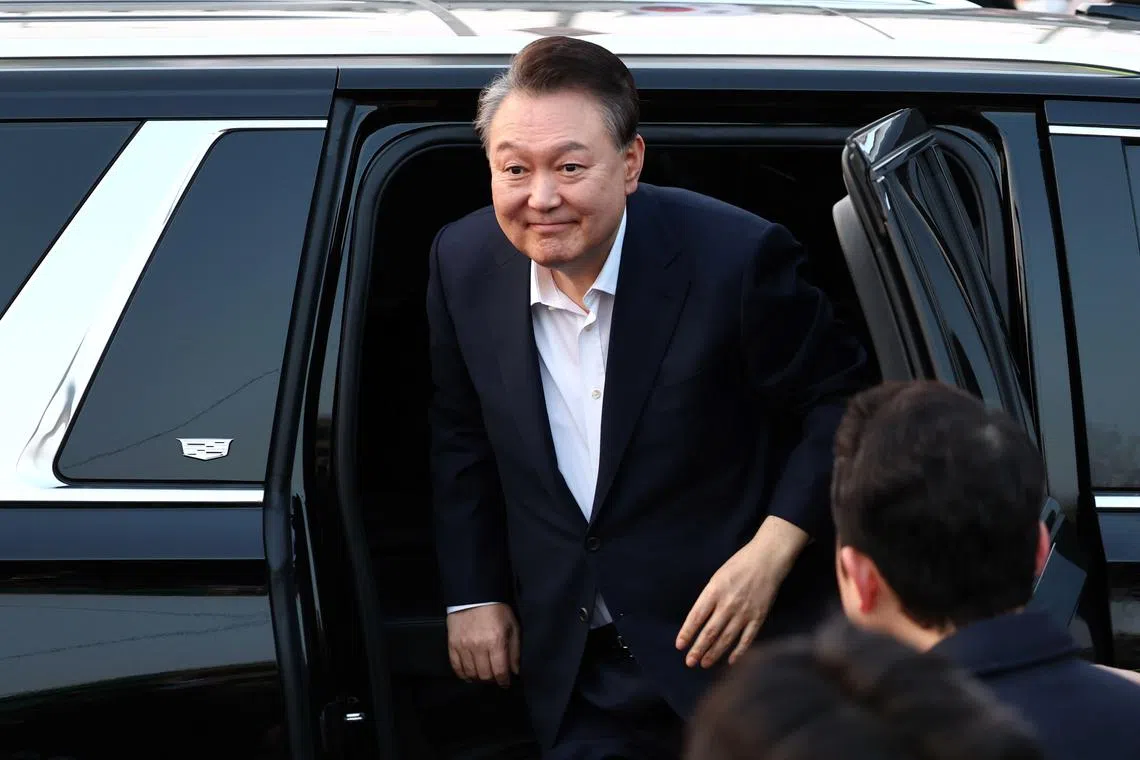 epa11948716 South Korea's impeached president Yoon Suk Yeol gets out of the Presidential Security Service vehicle as he arrives in front his official residence after being released from detention, in Seoul, South Korea, 08 March 2025. A South Korean court on 07 March lifted the arrest warrant for President Yoon over his brief imposition of martial law last December, clearing the way for his release from jail. EPA-EFE/YONHAP SOUTH KOREA OUT