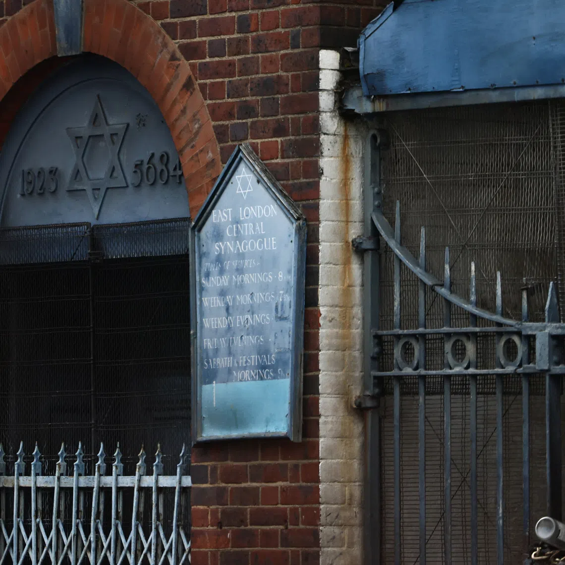 A sign hangs at the site of a suspected arson attack on a former synagogue in London.