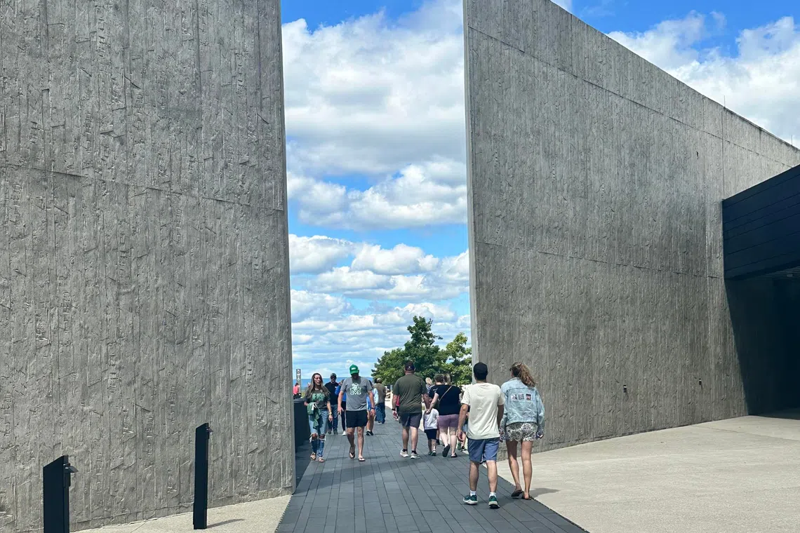 People walking over the black granite walkway that marks the flight path of United Airlines Flight 93. All 40 passengers and crew died on Sept 11, 2001, after attempting to retake the plane from 9/11 hijackers.
