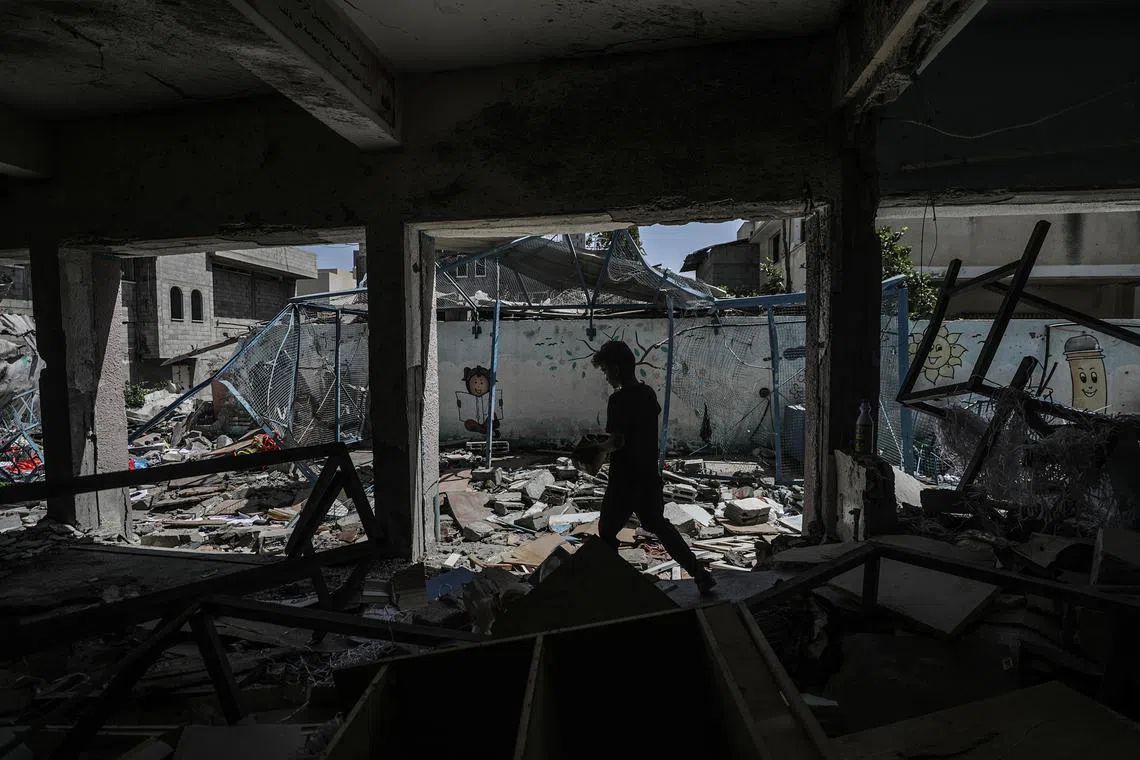 A boy walks among the rubble at a UNRWA-run school in central Gaza that was hit by an Israeli air strike. 