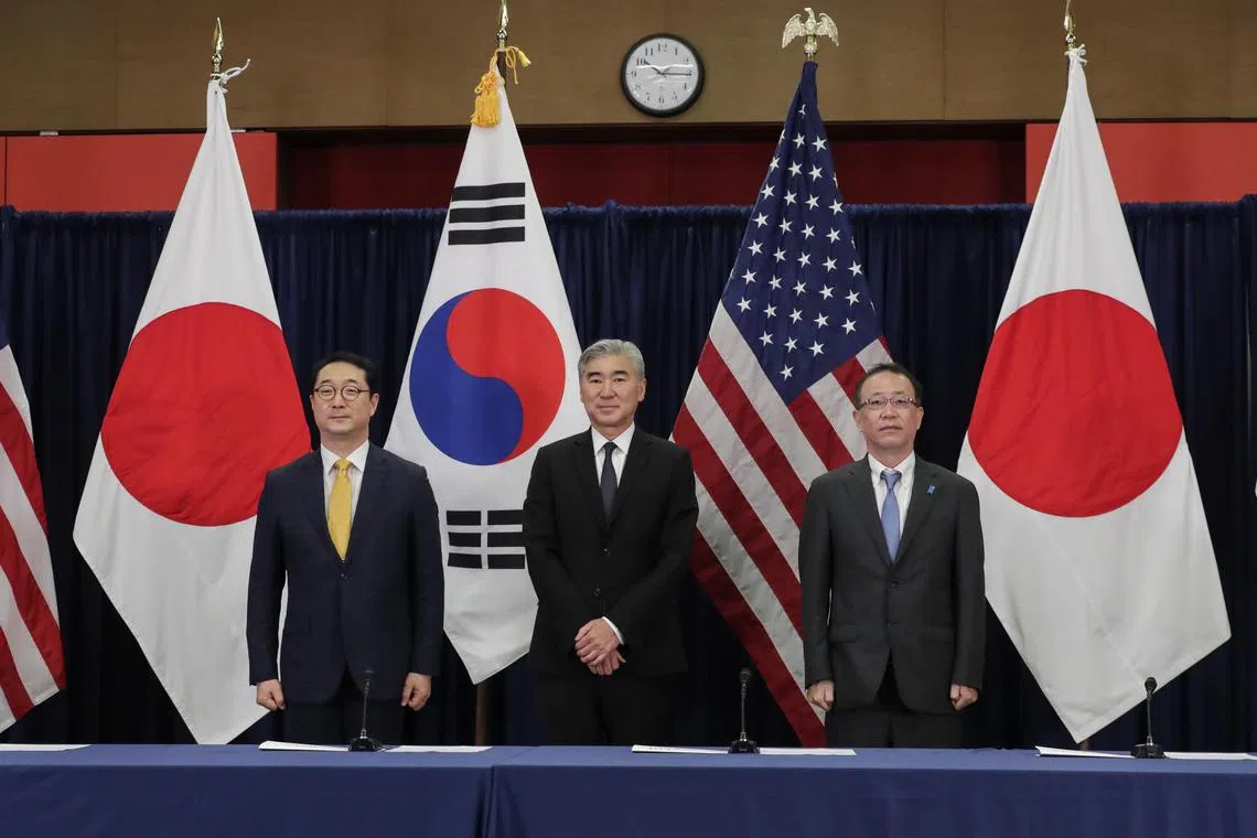 South Korea Special Representative for Korean Peninsula Peace and Security Affairs Kim Gunn (L), US Special Representative for North Korea Sung Kim (C) and Japan’s Ministry of Foreign Affairs Director-General for Asian and Oceanian Affairs Bureau, Funakoshi Takehiro (R) pose for photographs prior to the trilateral meeting on North Korea at the US Embassy in Jakarta, Indonesia on Dec 13, 2022.  