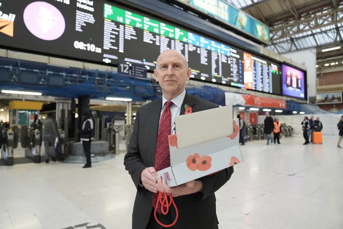 FILE PHOTO: Britain's Defence Secretary John Healey joins serving military personnel to hand out poppies and collect donations for the Royal British Legion Appeal during London Poppy Day, at Victoria Station, London, Britain. Picture date: Thursday October 31, 2024.   Stefan Rousseau/Pool via REUTERS/File Phooto