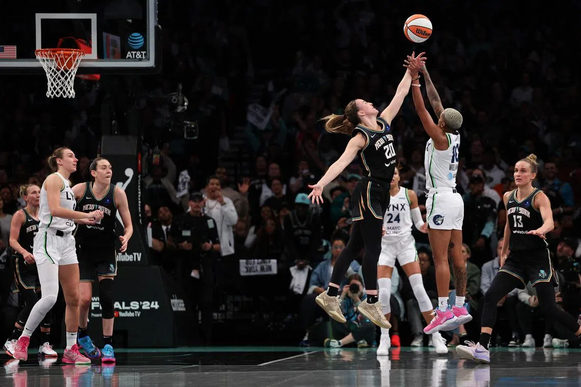 Courtney Williams of the Minnesota Lynx is fouled by Sabrina Ionescu of the New York Liberty during the second half of Game 1 of the WNBA Finals.