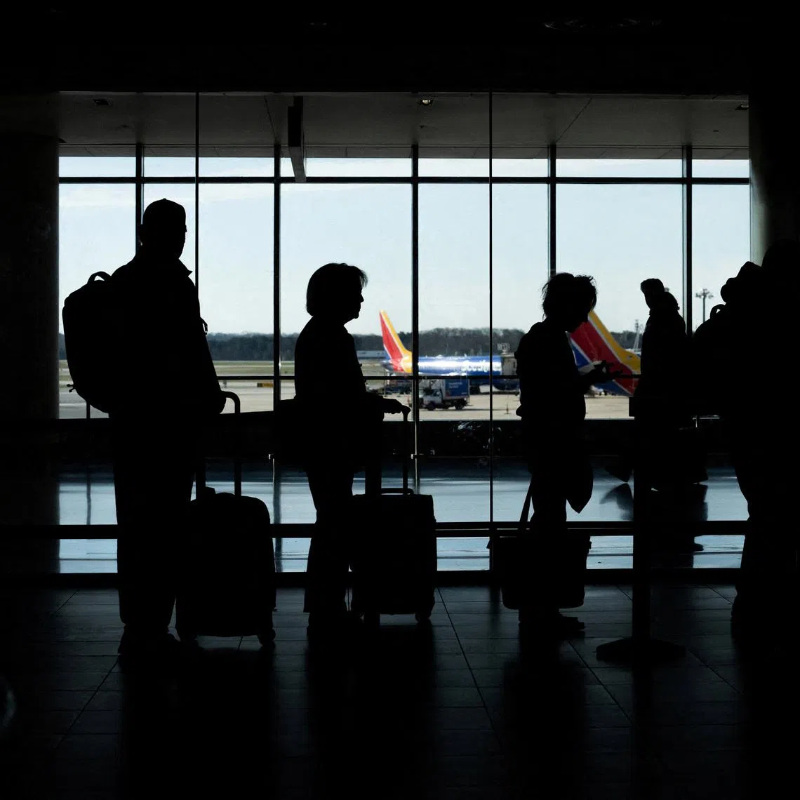 Passengers wait in a TSA security checkpoint queue in Baltimore on March 29.