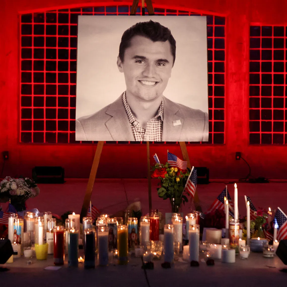 Candles and flowers are placed near an image of Charlie Kirk, during a vigil at Orem City Center Park, after U.S. right-wing activist and commentator, Charlie Kirk, an ally of U.S. President Donald Trump, was fatally shot during an event at Utah Valley University, in Orem, Utah, U.S. September 11, 2025.  REUTERS/Jim Urquhart/File Photo