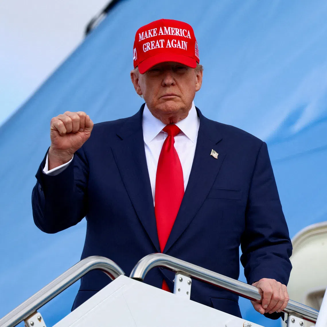 U.S. President Donald Trump gestures, while wearing a \"Make America Great Again\" cap, as he disembarks Air Force One, following his Asia trip, at Joint Base Andrews, Maryland, U.S., October 30, 2025. REUTERS/Evelyn Hockstein      TPX IMAGES OF THE DAY