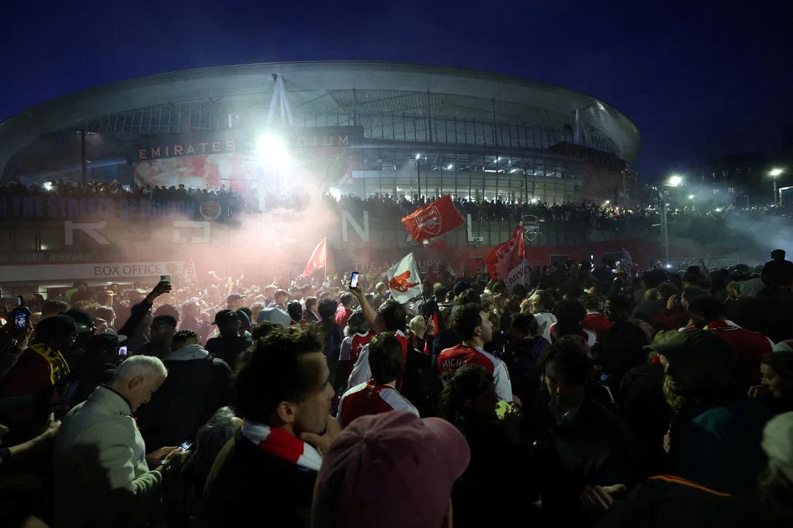 Arsenal fans celebrate outside the Emirates stadium as Arsenal win the Premier League. Action Images via Reuters/Andrew Boyers