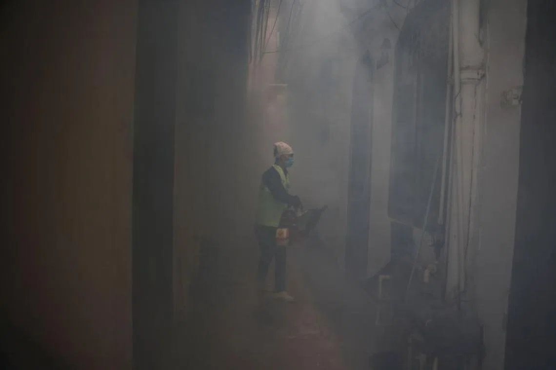 FILE PHOTO: A health worker fumigates interiors of a house in a residential neighbourhood to prevent the spread of mosquito-borne diseases following the rise in dengue cases in New Delhi, India, September 22, 2022. REUTERS/Anushree Fadnavis/File Photo