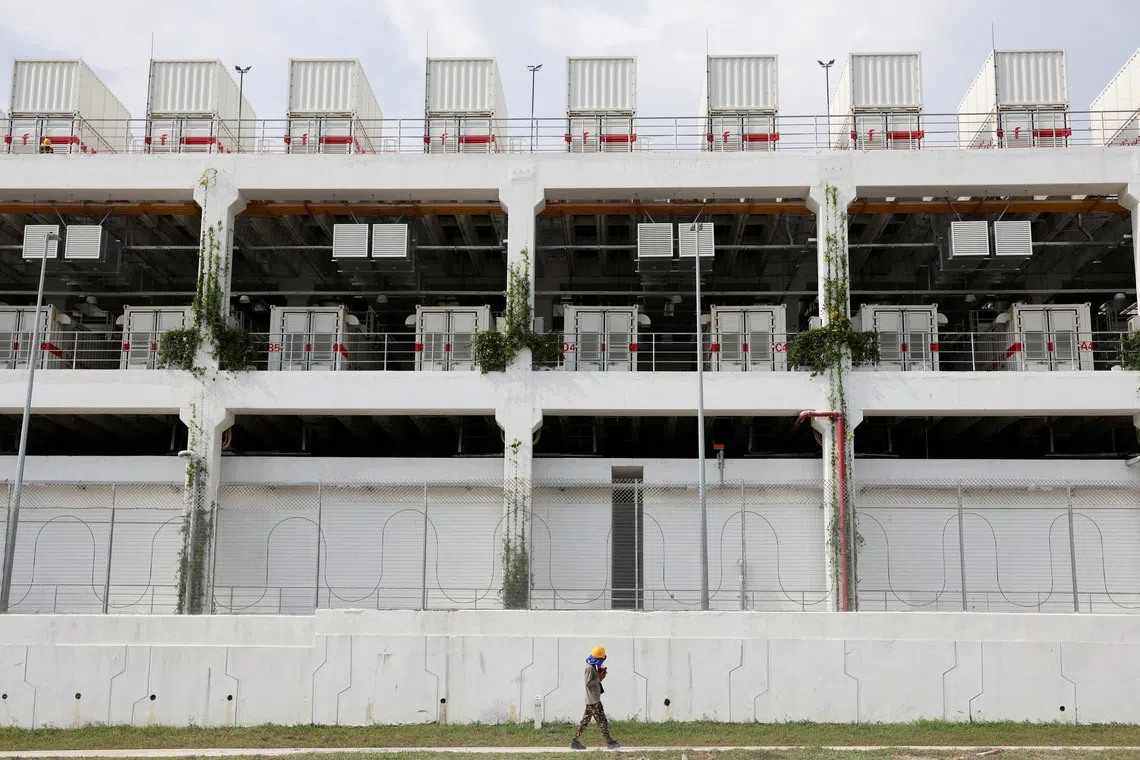 FILE PHOTO: File Photo: A worker walks past a data centre in Johor state, which has become Southeast Asia's fastest-growing data centre hub, at Gelang Patah, Malaysia May 7, 2026. REUTERS/Hasnoor Hussain/File Photo/File Photo
