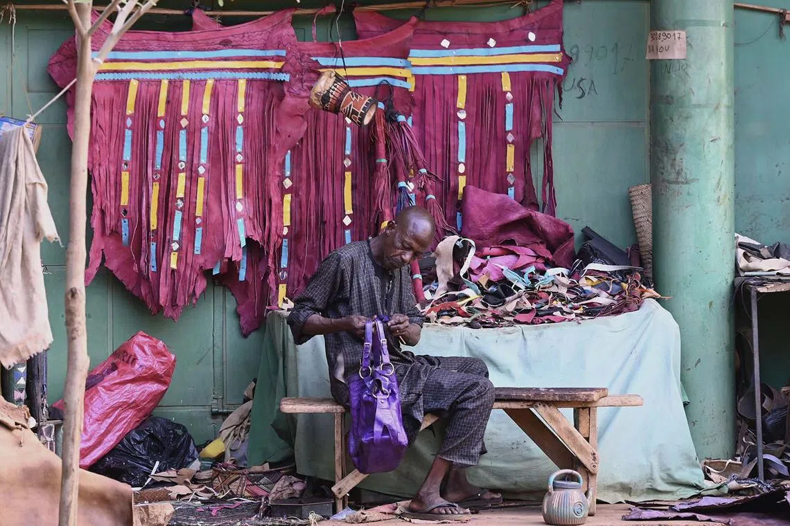 TOPSHOT - An artisans finishes his work at the craft centre in Niamey on September 21, 2023 (Photo by AFP)