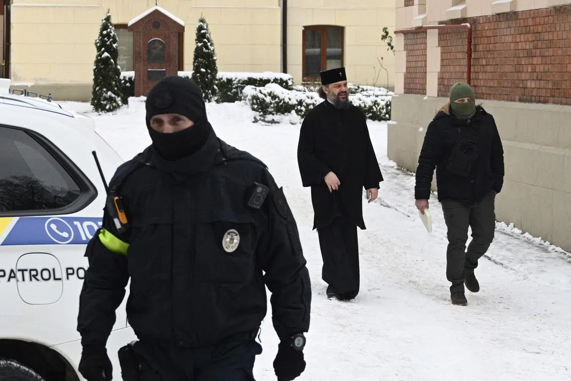 Officers with Ukraine's security service carry out a search at the St George Cathedral, in the Ukrainian city of Lviv, on Dec 14, 2022.