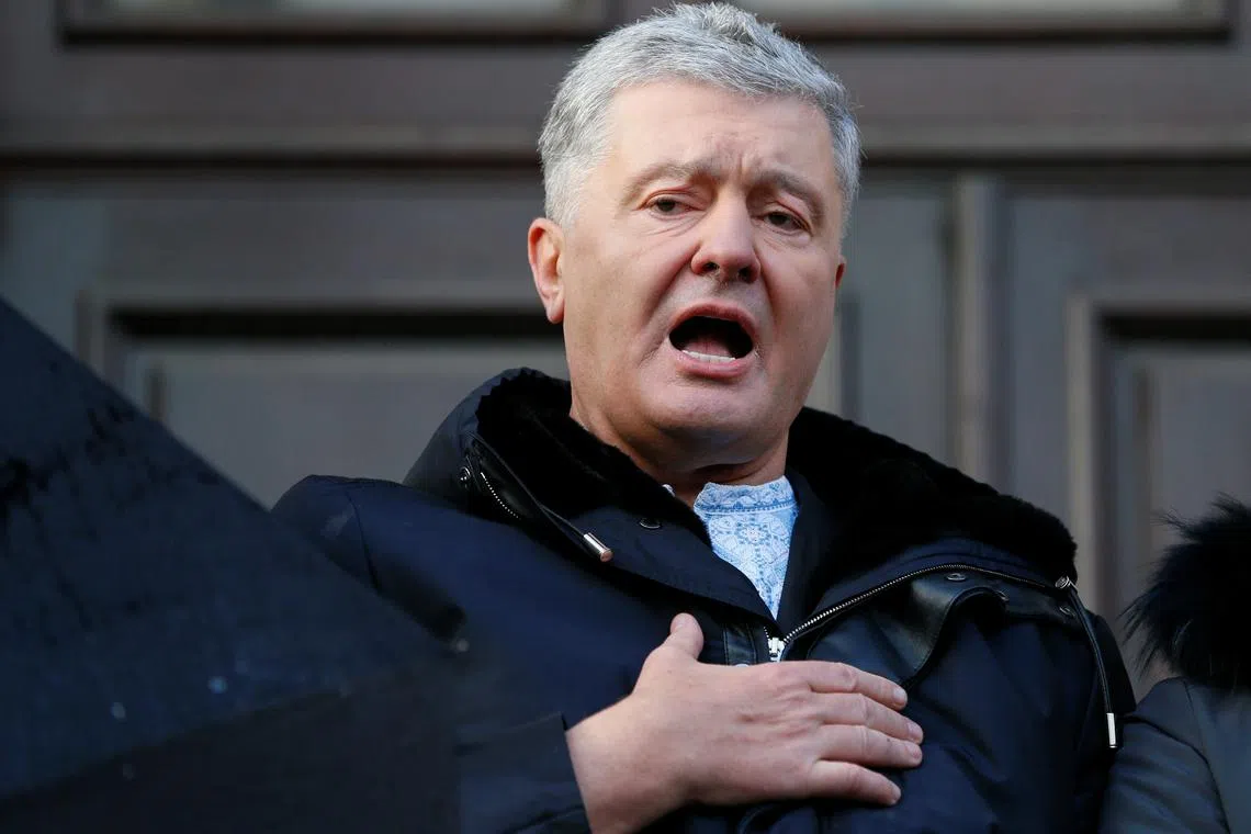 FILE PHOTO: Ukrainian former President Petro Poroshenko, who is suspected of high treason by financing pro-Russian separatists in eastern Ukraine while in office in 2014-2015, sings the national anthem after a court hearing in Kyiv, Ukraine January 19, 2022. REUTERS/Gleb Garanich/File photo