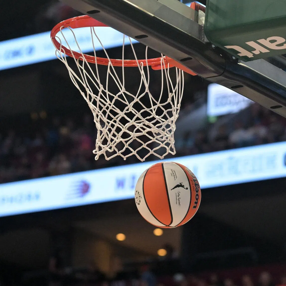 Jul 12, 2026; Montreal, Quebec, CAN; WNBA logo on ball and the net during the first half of a game. Mandatory Credit: Eric Bolte-Imagn Images