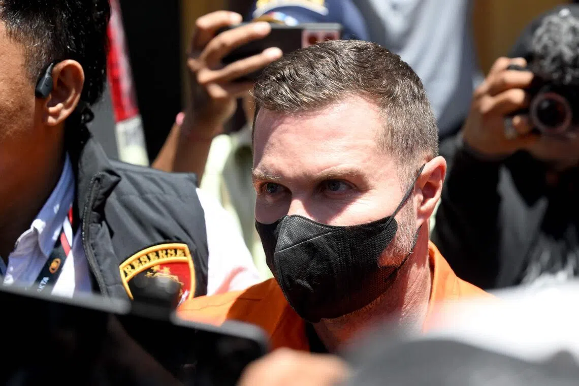 Scottish national Steven Lyons being escorted by police officers at the Bali police headquarters in Denpasar, on March 31.
