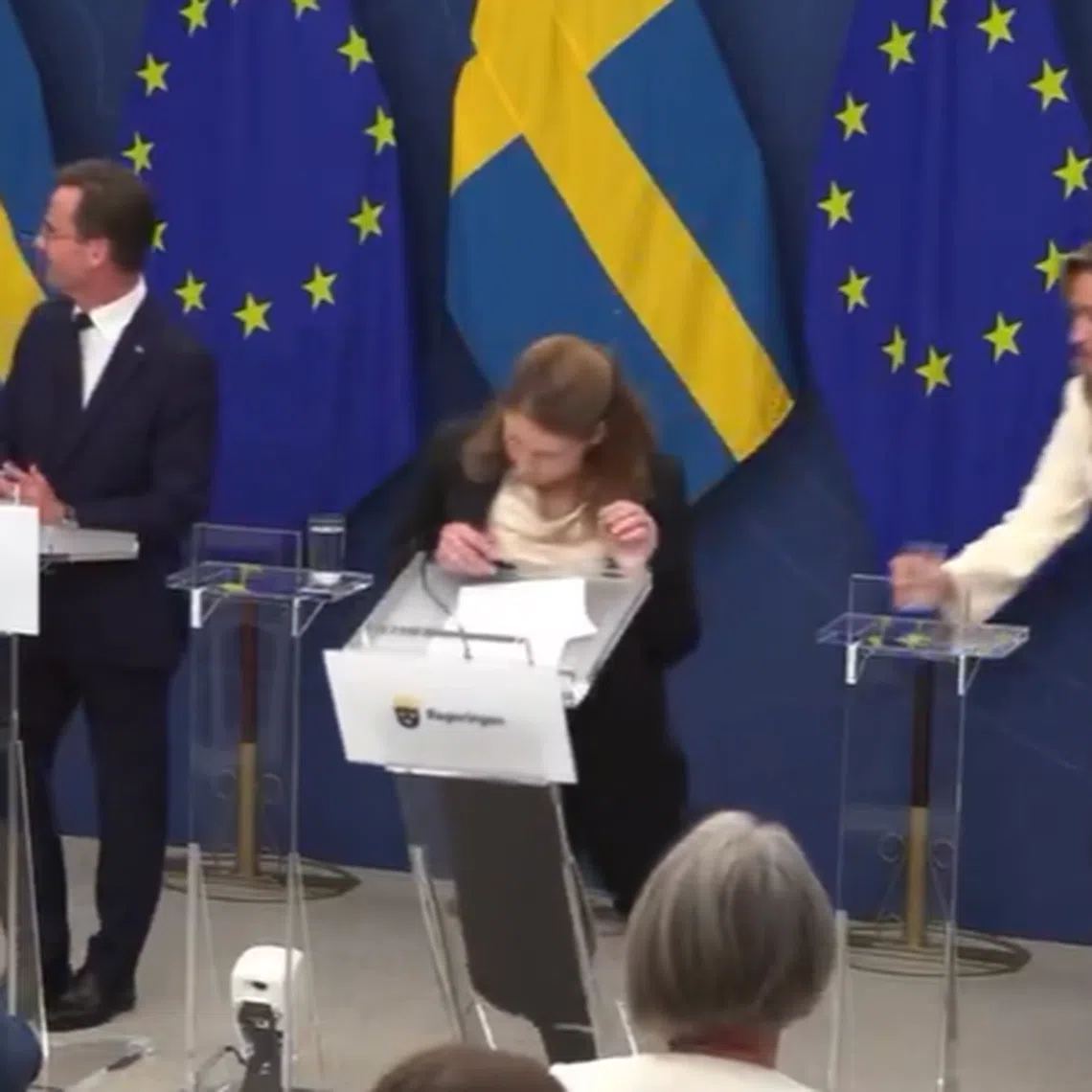 Videos, which has gone viral on social media, showed Ms Lann tumbled forward to the ground, taking a transparent lectern with her.