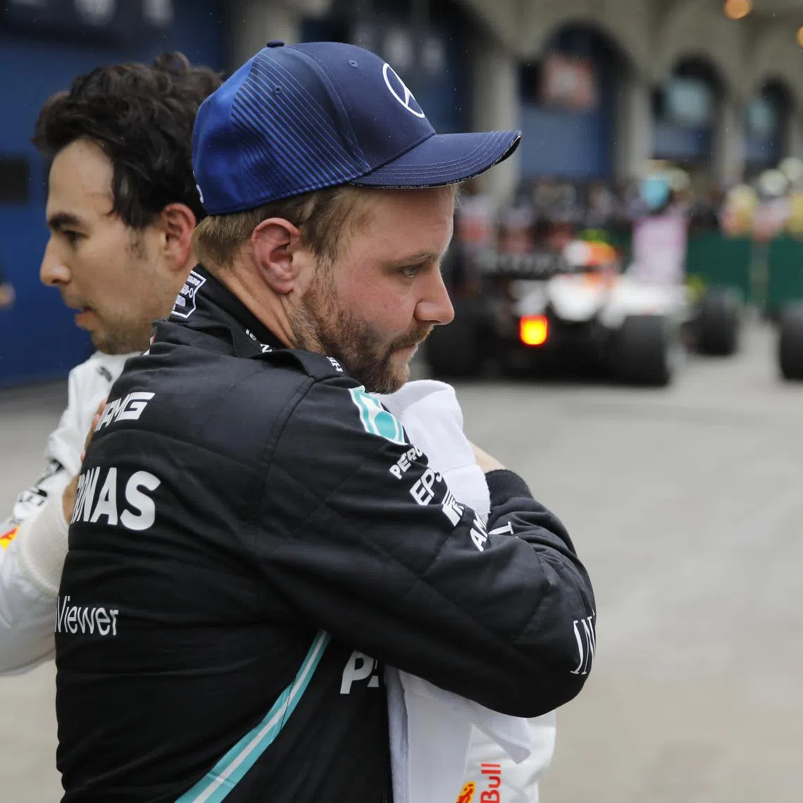 FILE PHOTO: Formula One F1 - Turkish Grand Prix - Intercity Istanbul Park, Istanbul, Turkey - October 10, 2021  Mercedes' Valtteri Bottas celebrates after winning the race with third placed Red Bull's Sergio Perez REUTERS/Umit Bektas/File Photo